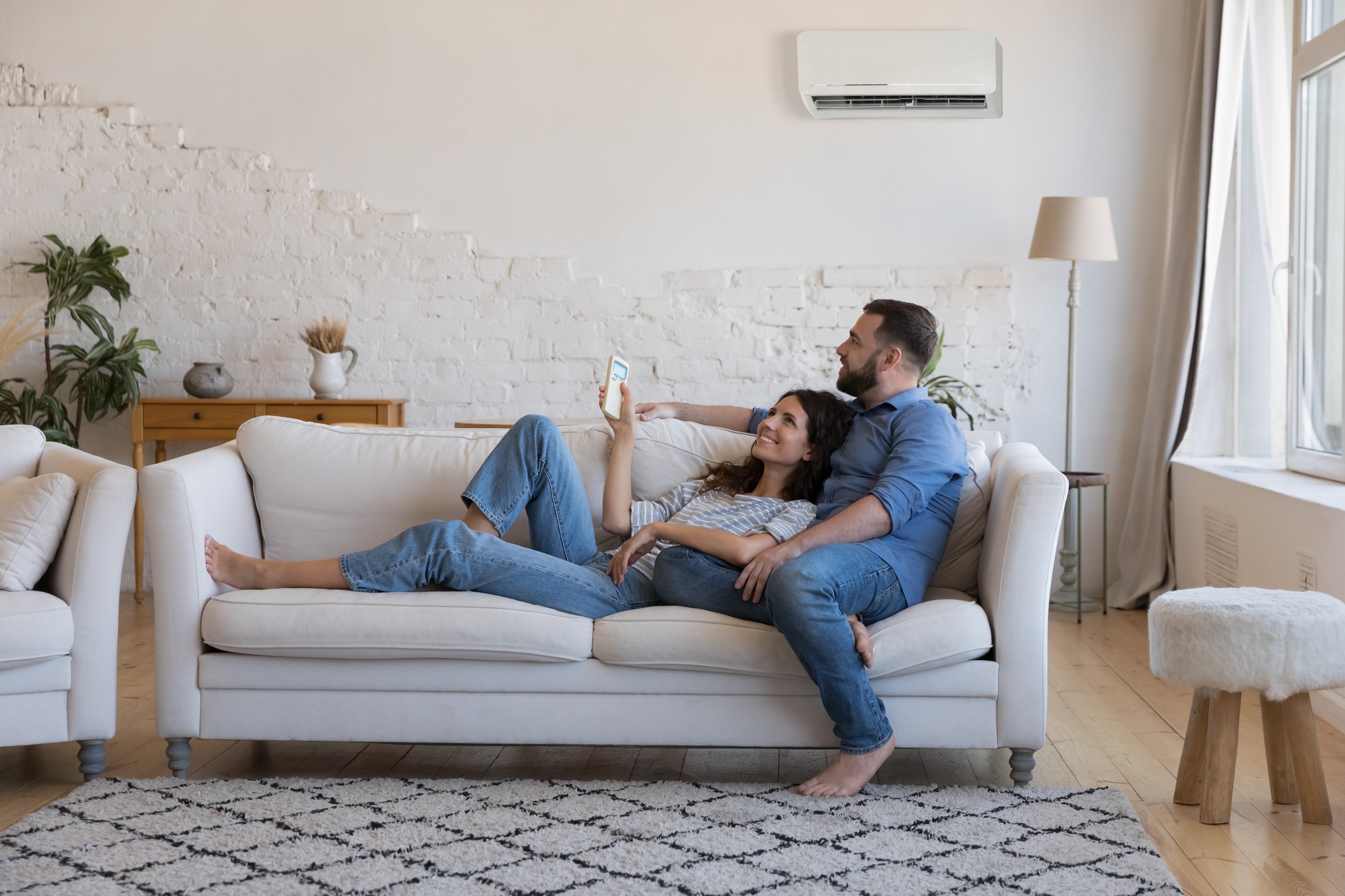 happy couple enjoying their new air conditioning unit